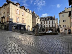 a cobblestone street in a city with buildings at ROUERGAT's LITTLE GITE in Villefranche-de-Rouergue