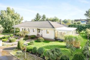 a small white house with a garden at Charming villa near the beach in Vejbystrand SE01066 in Vejbystrand