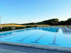 a large swimming pool with blue water at Charming villa near the beach in Vejbystrand SE01066 in Vejbystrand