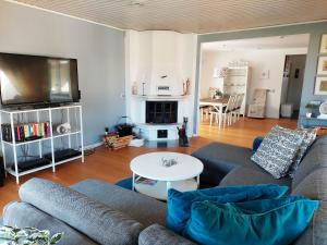a living room with a couch and a table at Charming villa near the beach in Vejbystrand SE01066 in Vejbystrand