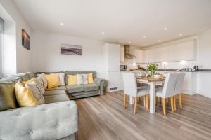 a living room with a couch and a table with chairs at 3 Bed in Tintagel oc-e32938 in Tintagel