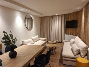 a living room with a couch and a table at Temples Du Soleil Tikal Appartements VTI in Val Thorens