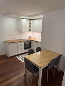 a kitchen with a wooden table and chairs at Cozy Urban Escape in Otepää