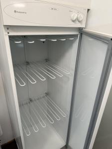 an empty refrigerator with its door open at Cozy Urban Escape in Otepää