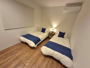 a room with two beds in a room with at Villa YUKUI in Onna