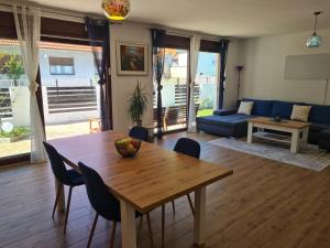 a living room with a table and a blue couch at OLD TOWN ROAD in Karlovac