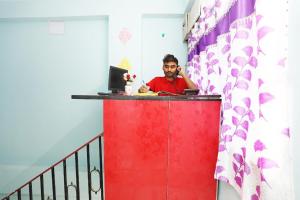a man talking on a cell phone at a desk at Star Hospitality in kolkata