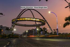 a metal arch in the middle of a street at night at Star Hospitality in kolkata +3 photos
