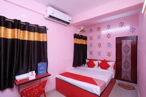 a bedroom with a bed with red and white at Star Hospitality in kolkata