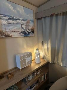 a living room with a television and a radio on a shelf at 52 Sherringham Way in Patrington +14 photos