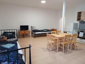 a room with a table and chairs and a bedroom at Apartmány MARTIN SARVAŠ in Tachov