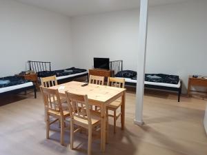 a table and chairs in a room with beds at Apartmány MARTIN SARVAŠ in Tachov