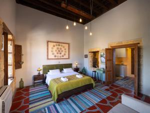 a bedroom with a large bed in a room at Colours - Old Town - Studios in Rhodes Town
