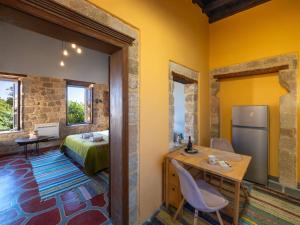 a room with a bed and a table and a refrigerator at Colours - Old Town - Studios in Rhodes Town