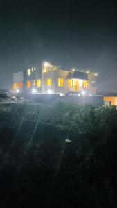 a house with its lights on at night at Nordik Hotel in Nkumba