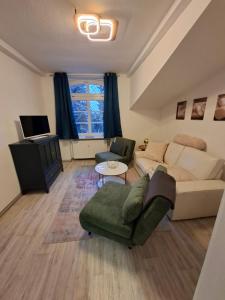 a living room with a couch and a tv at FeWo im Herzen Tarnows in Tarnow
