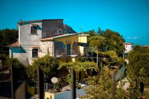 an old house with a fence in front of it at CASA DEL PAVONE - Capometa in Marzano +16 photos