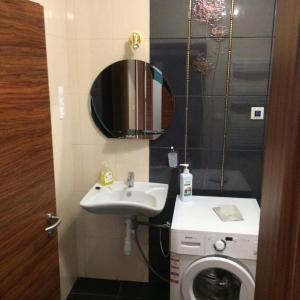 a bathroom with a sink and a washing machine at Szamos-Party Vendégház in Olcsva +24 photos