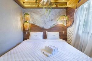 a bedroom with a large bed with a large rock wall at Leblon Beach Hostel in Rio de Janeiro +57 photos