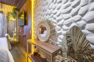 a room with a mirror and a wooden table at Leblon Beach Hostel in Rio de Janeiro
