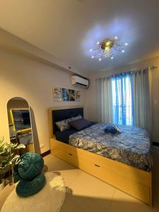 a bedroom with a bed and a chandelier at seakyung village in Suba