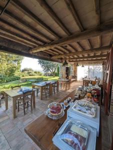 a patio with tables and chairs and a table with food at Agriturismo Podere Prataccio in Scansano