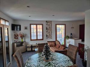 a living room with a table with a christmas tree on it at Charmante maison in Lacs