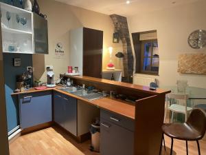 a kitchen with a sink and a counter top at le ROYAT in Royat +5 photos