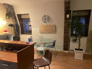 a living room with a table and chairs at le ROYAT in Royat