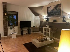 a living room with a couch and a tv and a table at le ROYAT in Royat