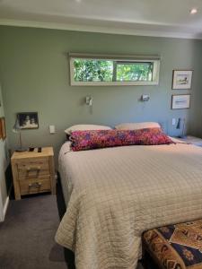 a bedroom with a bed and a window at Norfolk House in Gisborne