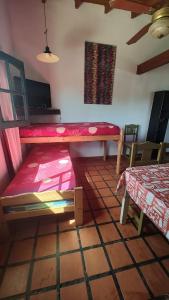 a room with a bed and a table in it at Zahra Depto in Villa Gesell +14 photos