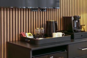 a tray with a coffee maker on top of a counter at Daresbury Park Hotel in Daresbury