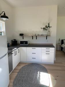 a kitchen with white cabinets and a kitchen rug at Sautee Nacoochee Studio near Helen in Sautee Nacoochee