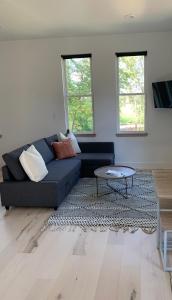 a living room with a blue couch and a table at Sautee Nacoochee Studio near Helen in Sautee Nacoochee