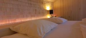a bedroom with two white pillows on a bed at Familienbauernhof Köss Schertler in Egg
