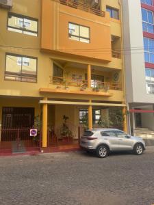 a car parked in front of a building at Hendy's cozy apt in Praia