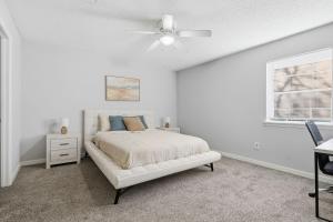 a white bedroom with a bed and a ceiling fan at Comfortable 2BR2BA with Modern Touches in Jackson