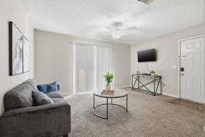 a living room with a couch and a tv at Comfortable 2BR2BA with Modern Touches in Jackson