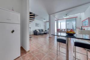 a kitchen and living room with a table and chairs at Villa Mariña- Heated pool in Playa Blanca +18 photos