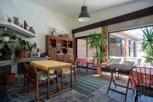 a kitchen with a table and chairs and a dining room at Villa dos Corcéis in Esposende