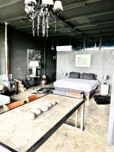 a bedroom with a bed and a table in it at Loft industrial Colchagua in Santa Cruz +48 photos
