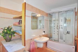 a bathroom with a sink and a shower and a toilet at villa between lake and mountains in Valbrona +16 photos