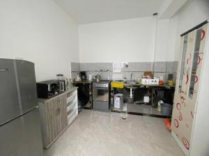 a kitchen with a refrigerator and a counter top at Antares Paracas in Paracas