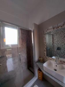 a bathroom with a shower and a sink at Calliope#2 in Skala +16 photos