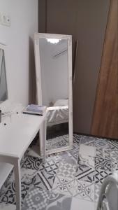 a mirror sitting on top of a room with a table at Calliope#2 in Skala