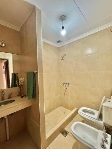 a bathroom with a shower and a toilet and a sink at Cabañas Tafi in Tafí del Valle +32 photos