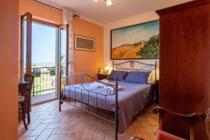 a bedroom with a bed and a large window at le stanze della Terrazza sul Borgo in Castel del Piano