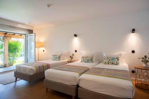 a bedroom with two beds and a window at Villa dos Corcéis in Esposende +57 photos