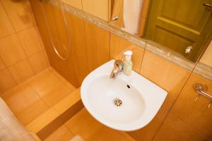 a bathroom sink with a soap dispenser on it at Zafir House Harghita Bai Ski in Harghita-Băi